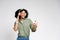 African-American woman with headphones, smiles at her phone