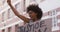 African american woman holding placard shouting raising fist during protest