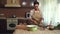 African American woman housewife fills a sterilized glass jar with chopped dill leaves, garlic while pickling vegetables