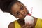 African American woman licks the topping of her milkshake
