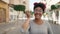 African american woman listening voice message by smartphone walking at street