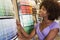 African American woman looking at paint swatches at hardware store