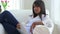 African American woman lounging on couch with tablet