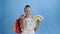 African american woman with money card and shopping bags. Blue background. White dress with flowers