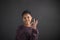 African American woman with perfect hand signal on blackboard background
