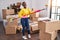 African american woman playing mop as a guitar cleaning at new home