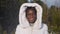 African-American woman poses and smiles under sparkling snow