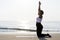 African American woman practicing yoga at the beach