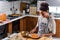 African american woman preparing pumpkin pie for holidays