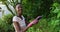 African american woman pruning plants in sunny garden smiling to camera