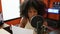 African american woman radio reporter reading script working at radio studio