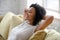 African American woman relax on comfortable couch at home