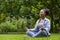 African American woman relaxingly practicing meditation in the forest to attain happiness from inner peace wisdom for healthy mind