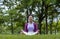 African American woman relaxingly practicing meditation in the forest to attain happiness from inner peace wisdom for healthy mind