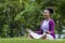 African American woman relaxingly practicing meditation in the forest to attain happiness from inner peace wisdom for healthy mind