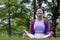 African American woman relaxingly practicing meditation in the forest to attain happiness from inner peace wisdom for healthy mind