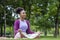 African American woman relaxingly practicing meditation in the forest to attain happiness from inner peace wisdom for healthy mind