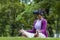 African American woman relaxingly practicing meditation in the forest using VR goggle virtual reality to attain inner peace wisdom