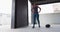 African american woman resting after exercising with medicine ball in an empty urban building