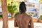 African american woman shirless standing on back view at park