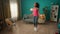 African American woman skipping rope at home in the living room. A cute slender woman takes care about her health by