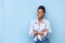 African american woman smiling with arms crossed on blue background