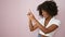 African american woman smiling pointing to the side over isolated pink background