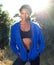 African american woman standing outdoors in blue sweatshirt