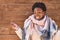 African american woman standing over wood background screaming proud, celebrating victory and success very excited with raised arm