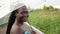 African-American woman with transparent umbrella on bridge