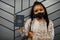 African american woman wearing black face mask show Saint Lucia passport in hand. Coronavirus in America country, border closure