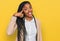 African american woman wearing business jacket smiling pointing to head with one finger, great idea or thought, good memory