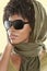 African American woman wearing sunglasses with stole over her head