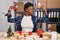 African american woman working at small business doing christmas decoration showing arms muscles smiling proud