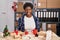 African american woman working at small business doing christmas decoration sticking tongue out happy with funny expression