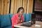 African american woman works in a call center operator and customer service agent wearing microphone headsets working on laptop