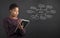 African American woman writing in book diary marketing diagram on blackboard background