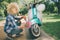 African American women washing motor scooter. Girl cleaning a the blue moped or motorcycle