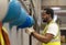 African American worker is hanging his safety helmet on the rack inside the heavy industrial factory for protection and accident