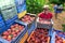 African american worker stacks crates of peaches in an orchard