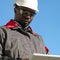 African american worker with tablet computer stands at construction site