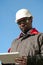 African american worker with tablet computer stands at construction site