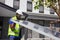 African American worker working on installing solar panel on the rooftop of the house for renewable energy and environmental