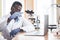 An African American worker works in a laboratory conducting experiments.