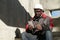 African american workman with smartphone at construction site