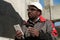 African american workman with smartphone at construction site