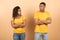 African american young couple standing separate and crossing hands, don't talk to each other after family quarrel