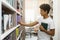 African american young guy choosing books at campus library