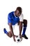 African american young male soccer player kneeling by ball against white background