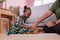 African Americans` mother and daughter playing block wooden games together in living room. black people or African Americans. Hom